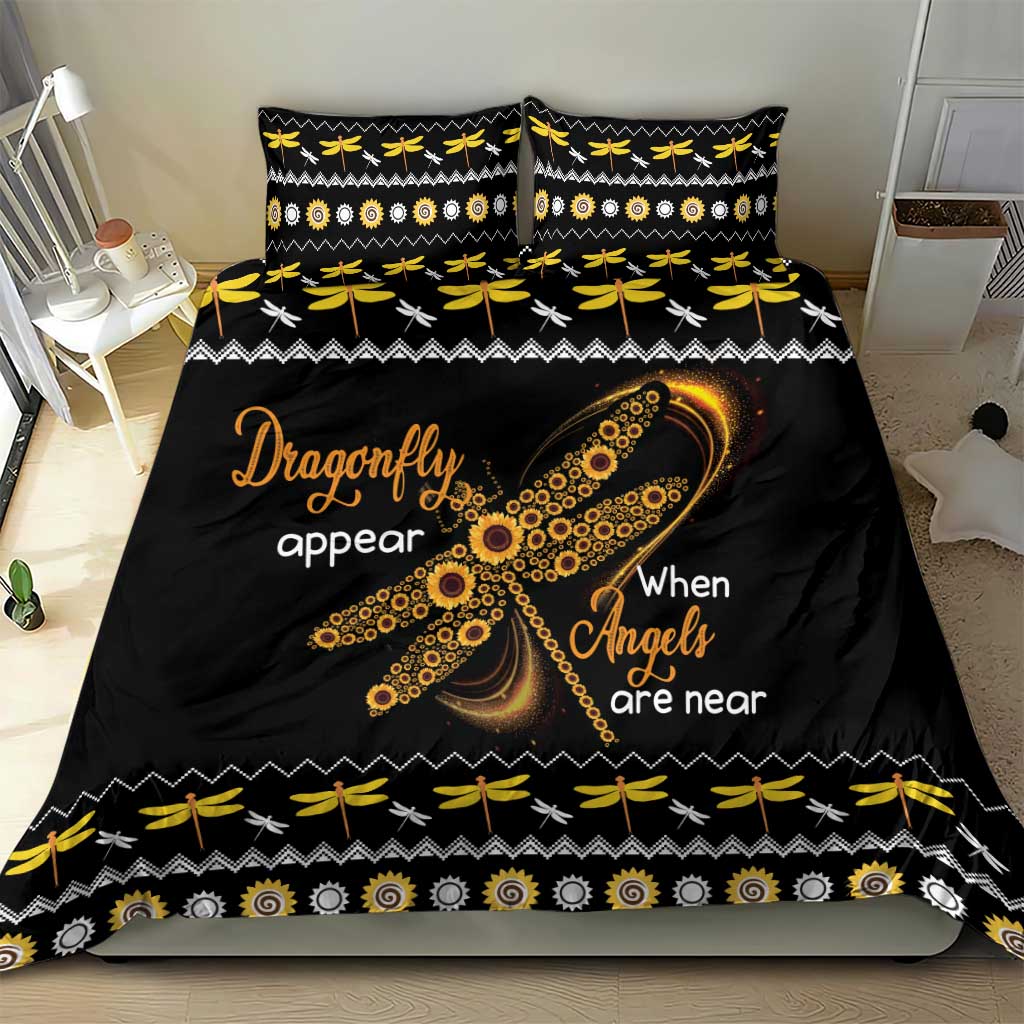 Black bedding set with gold dragonfly artwork and “When Angels are near” on duvet and pillows