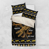 Black bedding set with gold dragonfly print and two pillowcases, bold geometric trim