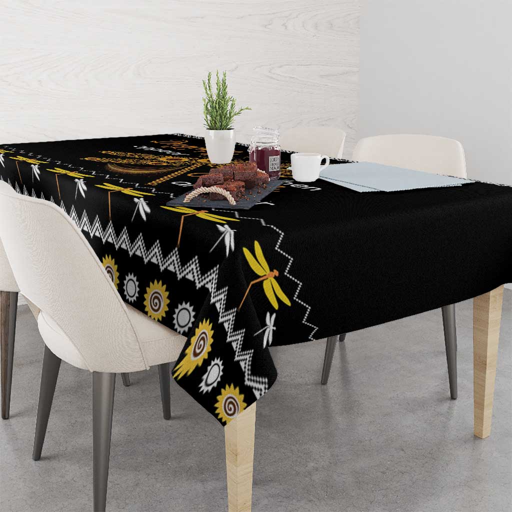Black tablecloth with golden spiral sun motifs, zigzag trim, and yellow dragonfly details