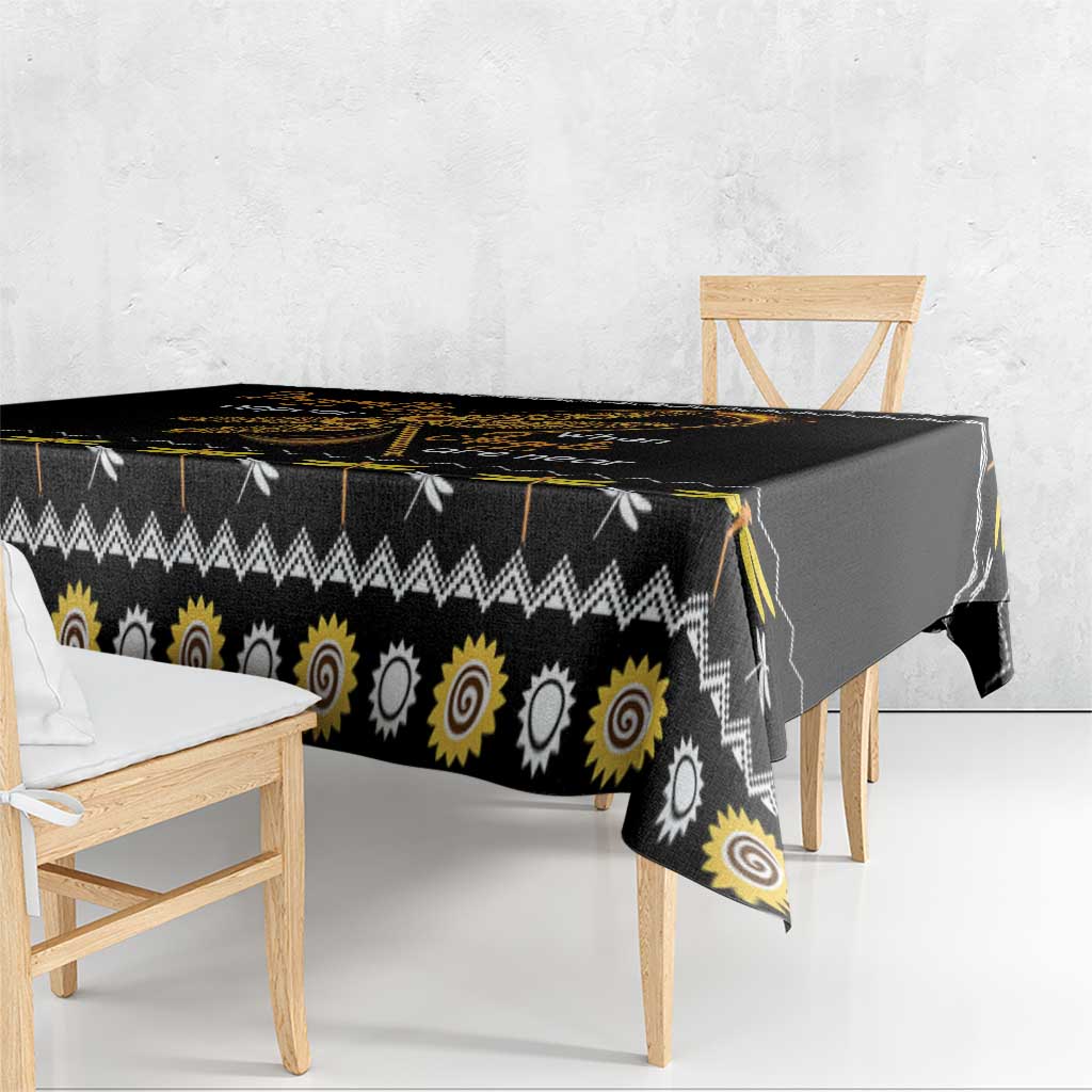 Black tablecloth corner with golden spiral sun circles and zigzag edge