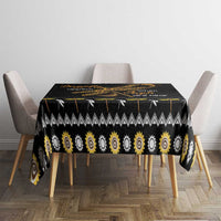 Black tablecloth with golden sun spiral pattern and small dragonfly graphic on dining table