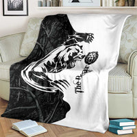 Black and white bear tattoo blanket with split black/white bear illustration on couch