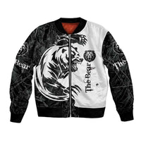Black and white bomber jacket with front zipper, bear tattoo print, ribbed cuffs; red neck lining