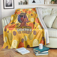Yellow blanket with African woman portrait, 'She believed...' text, and circular pattern