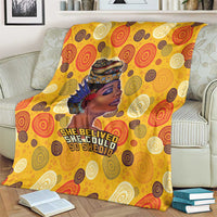 Yellow blanket with African woman profile and bold 'She believed she could' text