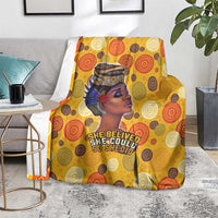 Yellow blanket on couch with African woman portrait and 'She believed...' slogan print