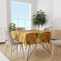 Yellow tablecloth with colorful circular pattern on dining table