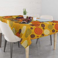 Yellow tablecloth with circular motifs draped over dining table corner