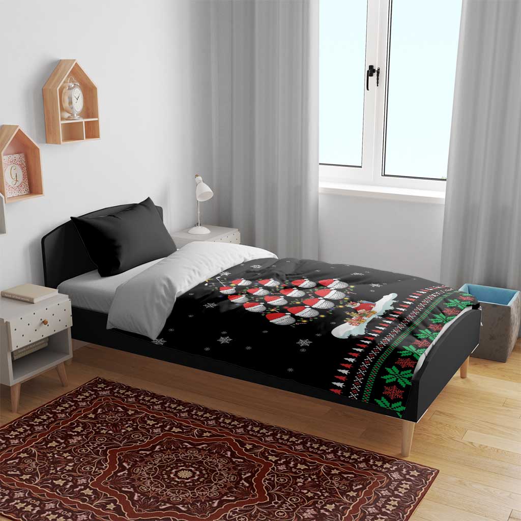 Black Christmas bedding set with penguin family print and holiday border on a bed