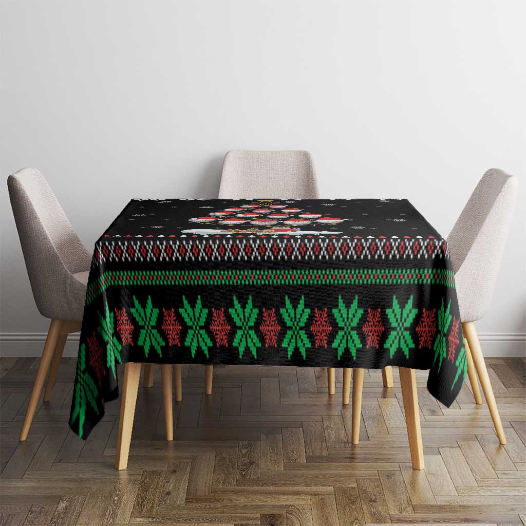Black Christmas tablecloth with green pine and red pattern, centered on dining table