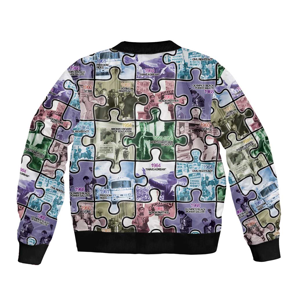 Unisex puzzle bomber jacket with colorful patchwork puzzle print, ribbed black hem and cuffs