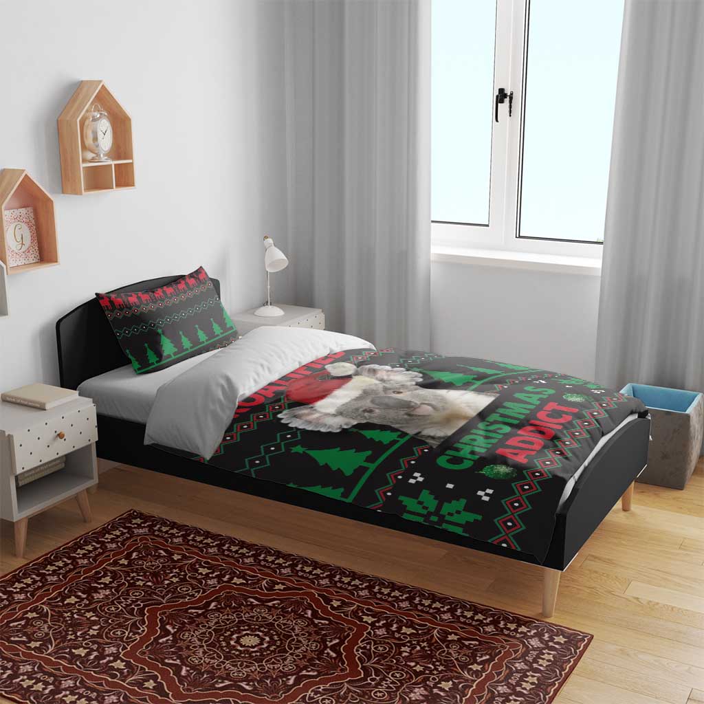 Koala Christmas bedding set on bed: dark duvet with green trees and CHRISTMAS ADDICT print