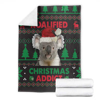 Koala Christmas blanket with Santa-hat koala, folded and paired with stacked white towels