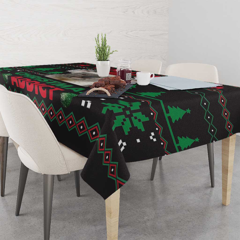 Black Christmas tablecloth with green pixel-like trees and patterned border