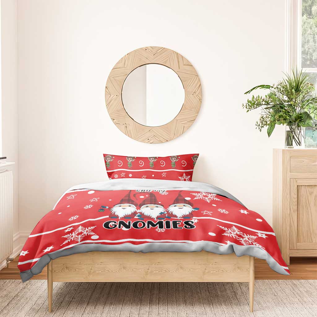 Red gnomes duvet with “GNOMIES” text and snowflakes, styled on a wooden bed frame