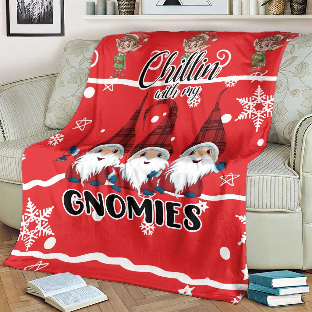 Red Christmas gnomies blanket on a couch, “Chillin with my GNOMIES” graphic with snowflakes
