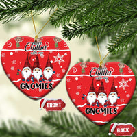 Red ceramic heart-shaped ornament set with gnomes graphic and gold hanging loop.