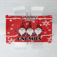 Red Christmas tablecloth with gnomes, snowflakes, stars, and festive text design.