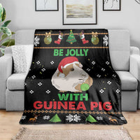 Black Christmas blanket spread on a sofa, guinea pig graphic and “Be Jolly with Guinea Pig”