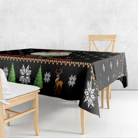 Black Christmas tablecloth with green trees, snowflakes, and reindeer graphic