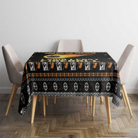 Black tablecloth on dining table with orange fireball band and repeating icon stripe