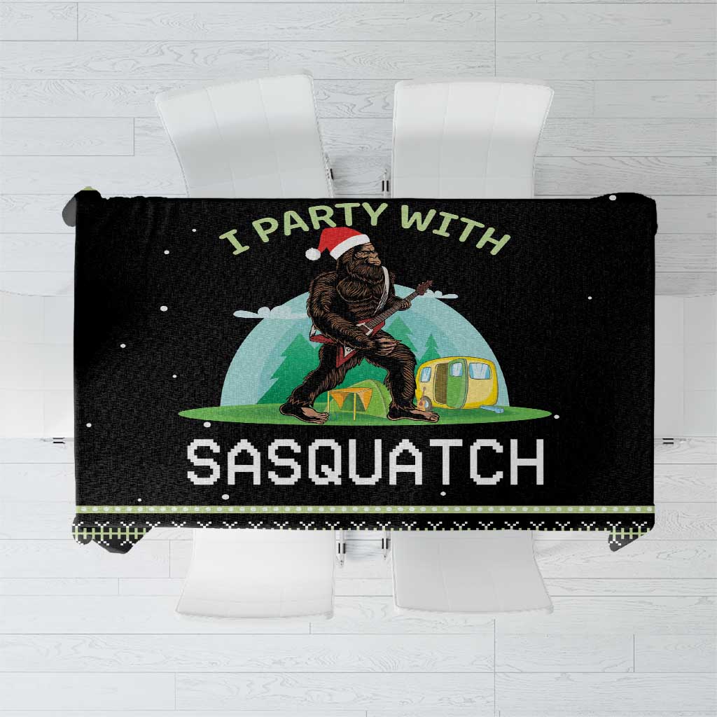 Black camping tablecloth with Sasquatch graphic and outdoor campfire scene
