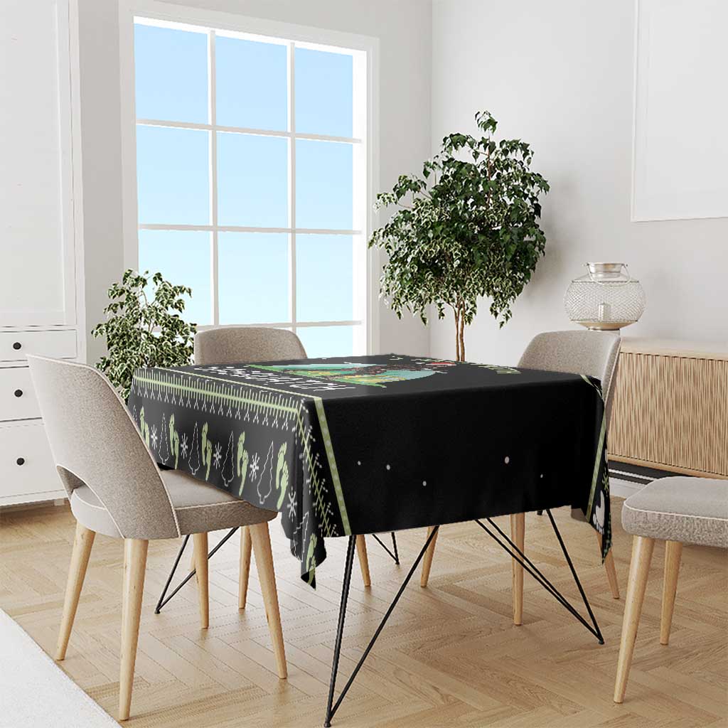 Black tablecloth with pine tree and snowflake pattern, draped over dining table