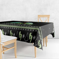 Black tablecloth with repeating pine tree motifs and green snowflake accents