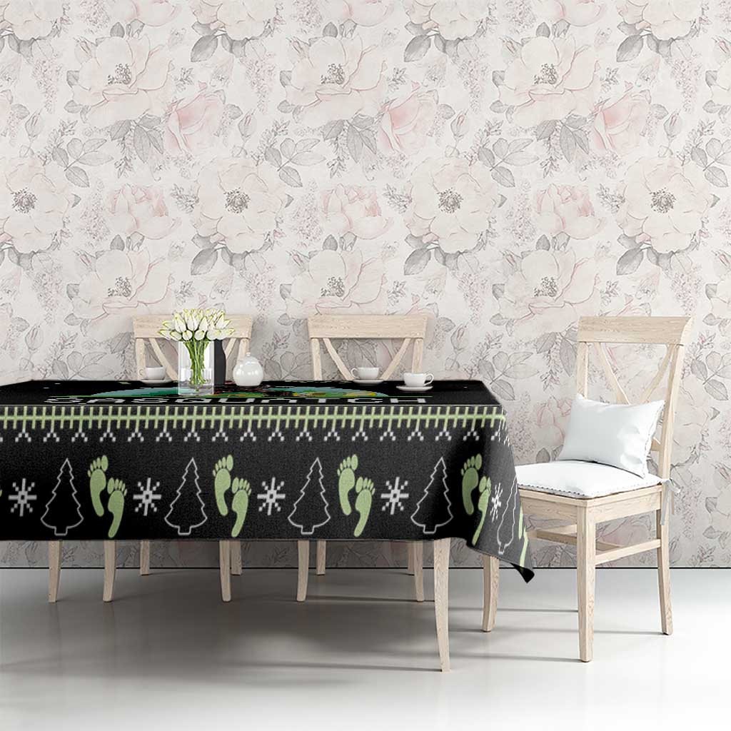Black tablecloth with pine tree silhouettes and snowflake pattern on dining table