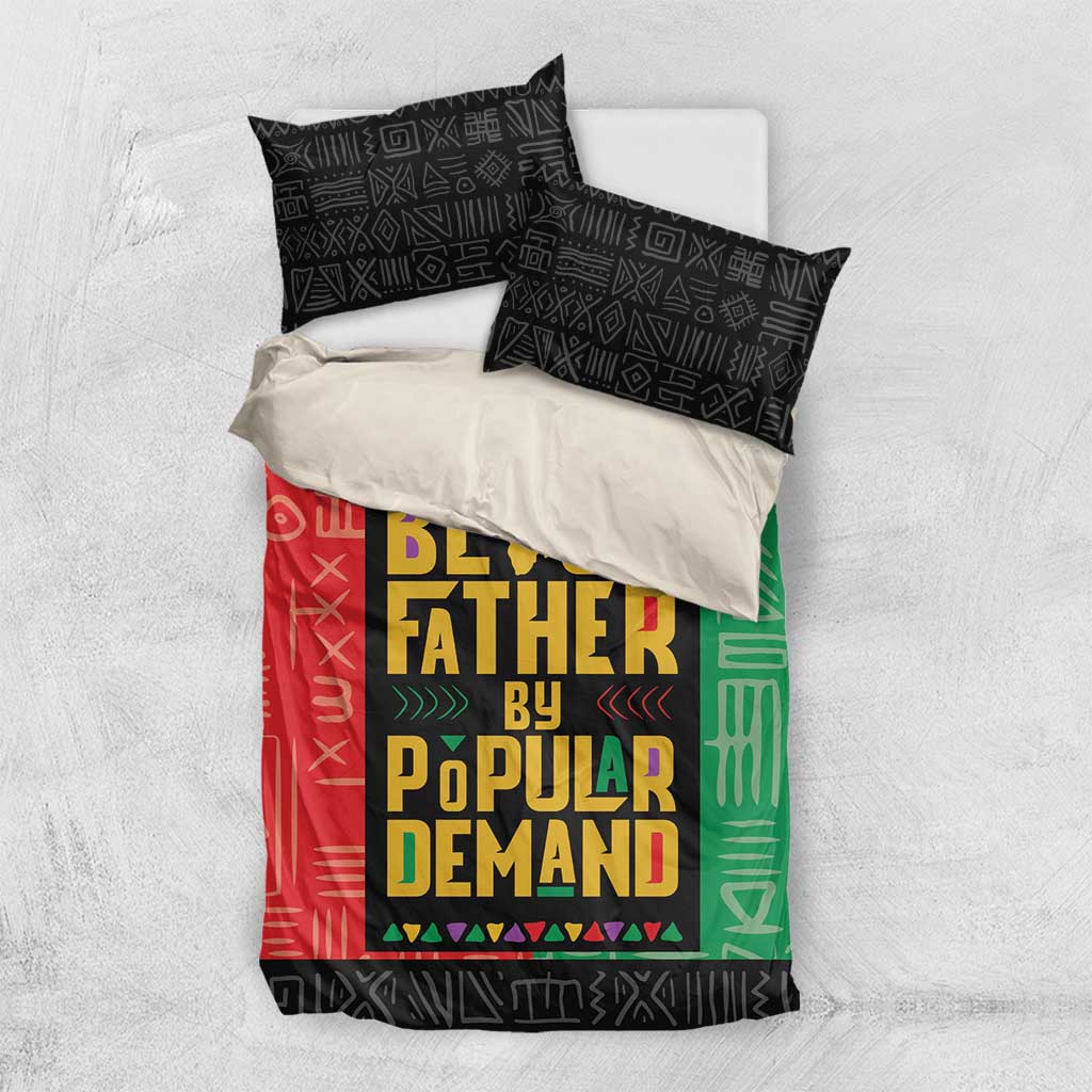 African bedding set with duvet and 2 black geometric pillowcases; red/black/green design.