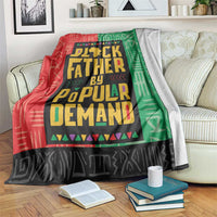 Colorful patterned African blanket with black, red, and green typography design