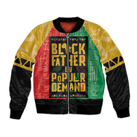 African bomber jacket with black sleeves, ribbed cuffs, and multicolor front text panel
