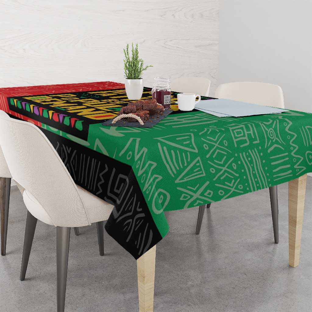 African tablecloth corner with green and black geometric motifs and patterned trim