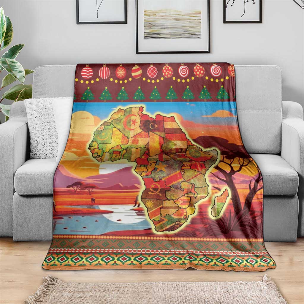 Red Africa map Christmas blanket laid on gray couch with festive tree and ornament trim
