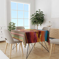 Christmas tablecloth with bold orange center and green patterned trim on table