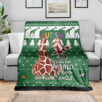 Green giraffe autism blanket spread over grey sofa