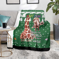 Green giraffe autism blanket draped on chair with Seeing the World from Different Angle