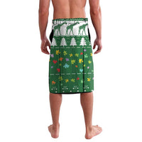 Green printed lavalava with giraffe silhouettes, trees, and multicolor puzzle-piece motifs.