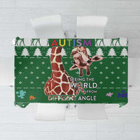 Green tablecloth folded top view with giraffe illustration and “Autism” text