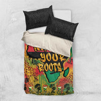 Bedding set flat lay with black geometric pillowcases and multicolor graffiti African map cover