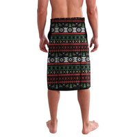 Men's black, green and red patterned lavalava shorts, front view to knee