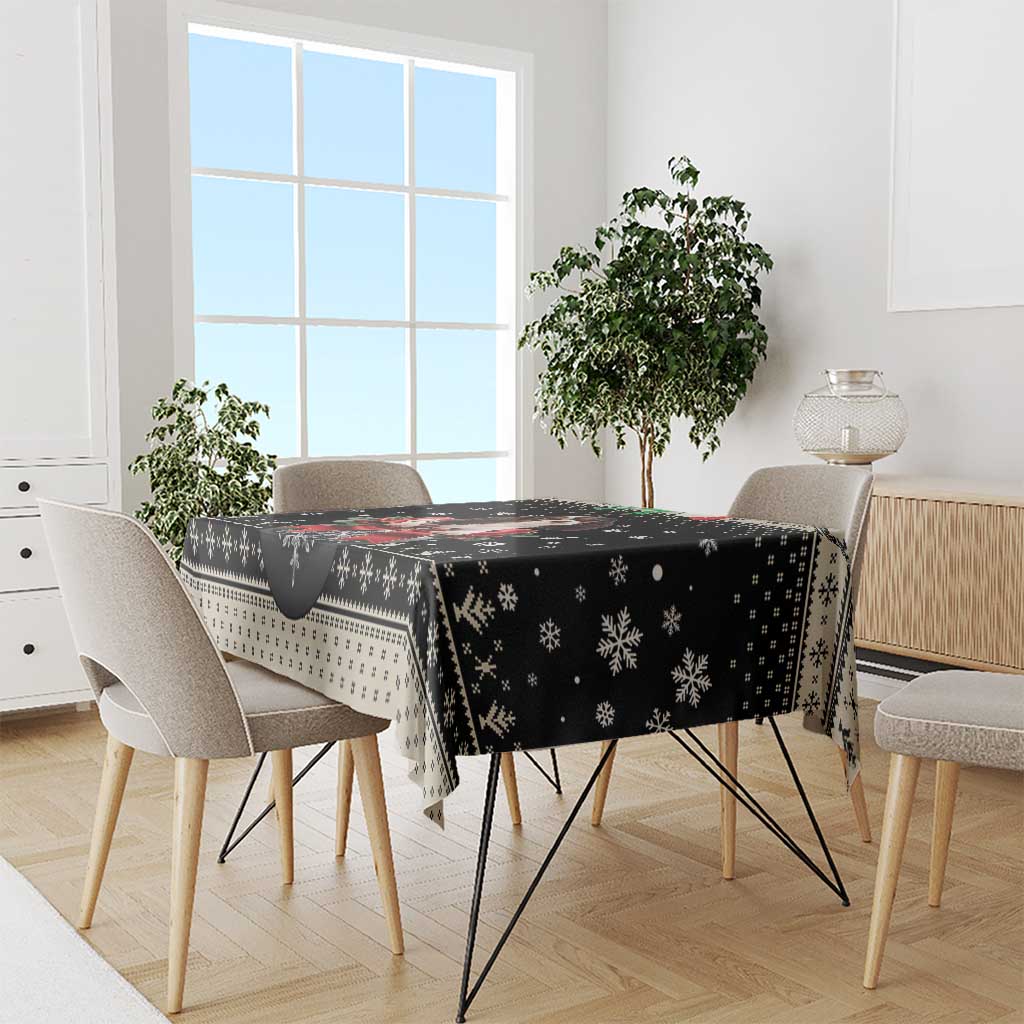 Black Christmas dog tablecloth draped on rectangular dining table with snowy pattern