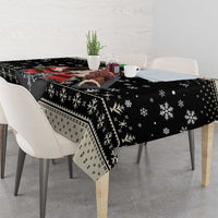 Black holiday dog tablecloth with snowflake and knit-style banding pattern on table