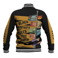 Black unisex baseball jacket with gold back graphic, striped collar and ribbed hem