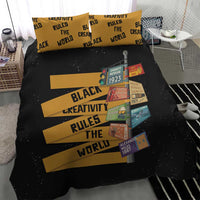 Black bedding set featuring gold bars, “Black Creativity Rules The World” text, portraits