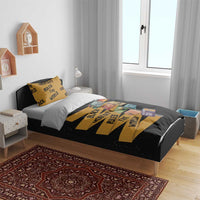Black bedding set with gold text stripes and colorful character card graphic layout