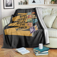 Black throw blanket with bold striped quote graphic and colorful collage patches
