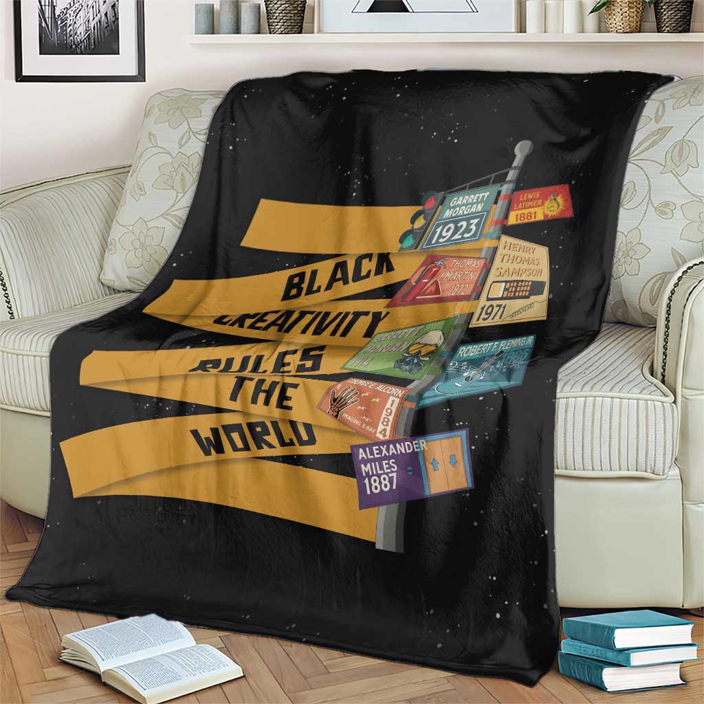 Black blanket draped on sofa with colorful quote graphic and small vertical patch labels
