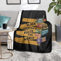 Black throw blanket draped on sofa seat with quote stripes and colorful patch collage
