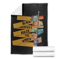 Black throw blanket with colorful striped quote text and collage patch design